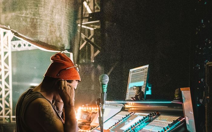 Sound technician managing audio controls during a live event