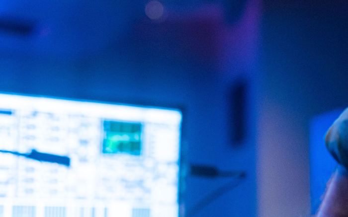 Technician adjusting a control panel during a live production